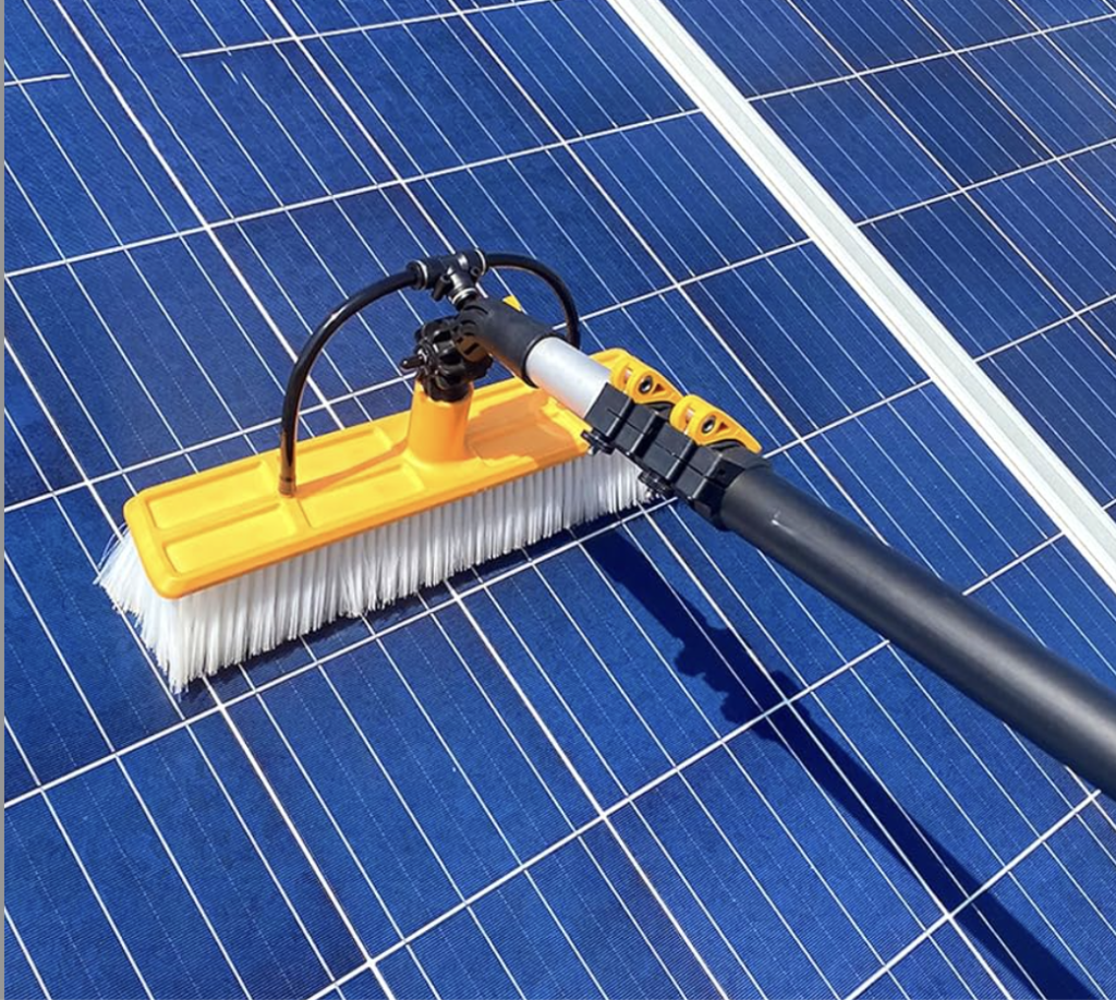 Water-fed brush cleaning solar panels